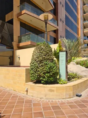 a sign on a sidewalk in front of a building at Palm Jumeirah 1BR luxurious & gorgeous view in Dubai