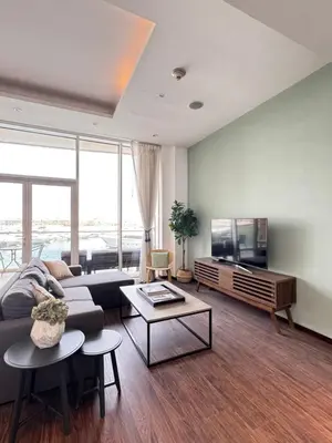 a living room with a couch and a flat screen tv at Palm Jumeirah 1BR luxurious & gorgeous view in Dubai