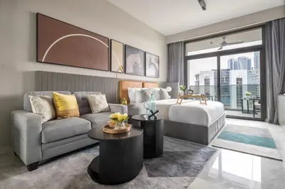 a living room with a couch and a bed at Frank Porter - MAG 318 in Dubai