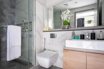 a bathroom with a toilet and a sink and a mirror at Frank Porter - MAG 318 in Dubai