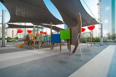 a group of chairs and a playground with a slide at Frank Porter - MAG 318 in Dubai