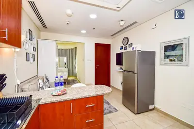 a kitchen with a refrigerator and a counter at Luxury Escapes - Budget Cozy Studio in Dubai Gate 2 JLT in Dubai
