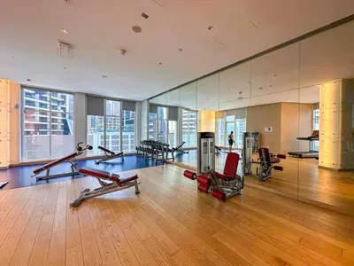 a gym with treadmills and exercise equipment in a building at AWS Holiday Homes - Panoramic Canal View in Dubai