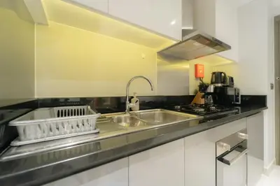 a kitchen with a sink and a stove at AWS Holiday Homes - Panoramic Canal View in Dubai