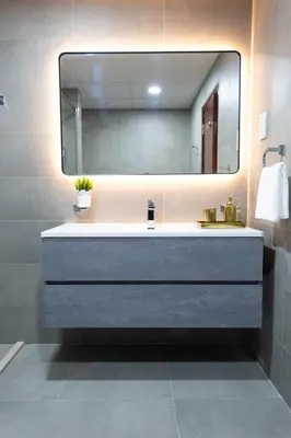 a bathroom with a sink and a large mirror at JBR apartments by HAPPY SEASON in Dubai