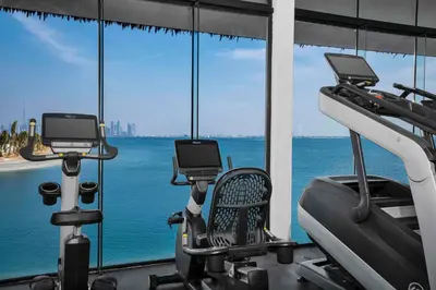 a gym with a view of the ocean at Anantara World Islands Dubai Resort in Dubai