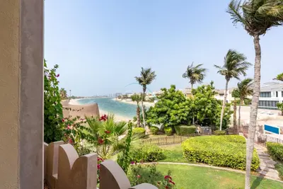 a view of the ocean from the balcony of a condo at Luxury Beachfront Villa with Direct Beach Access, Next to Community Pool, Close to the Thrills of Aquaventure Waterpark, Canal Cove, Palm Jumeirah by Deluxe Holiday Homes in Dubai