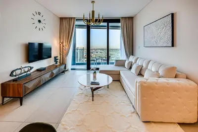 a living room with a couch and a tv at Brand New 5* Luxury Apartment in Address JBR in Dubai