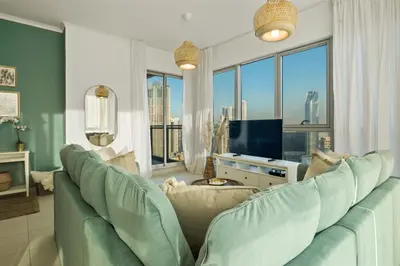 a living room with a couch and a television at Chic and Zen Apartment, Near Burj Khalifa Tower in Dubai