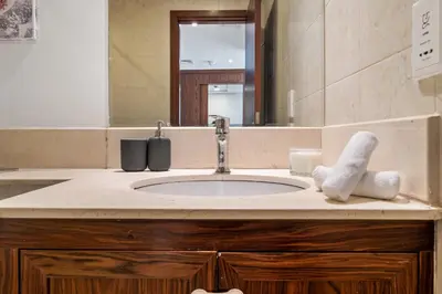 a bathroom counter with a sink and a mirror at Chic and Zen Apartment, Near Burj Khalifa Tower in Dubai