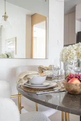 a dining room table with a bowl of fruit on it at Frank Porter - The Address JBR in Dubai