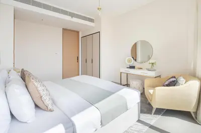 a bedroom with a bed and a chair and a mirror at Frank Porter - The Address JBR in Dubai