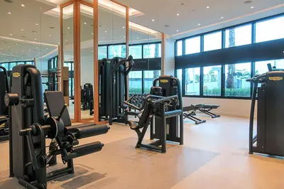 a gym with a bunch of treadmills and machines at Frank Porter - The Address JBR in Dubai