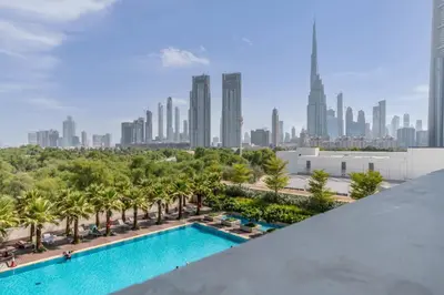 a view of the city from the rooftop of a building with a swimming pool at Silkhaus studio in DIFC with Burj Khalifa view, pool & gym in Dubai