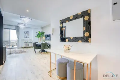 a living room with a table and a mirror at Elegant 2BR at Bahar 2 JBR by Deluxe Holiday Homes in Dubai