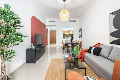 a living room with a couch and a table at The Smart Concierge - Plaza residences in Dubai
