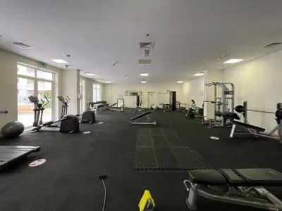 a gym with treadmills and machines in a room at The Smart Concierge - Plaza residences in Dubai