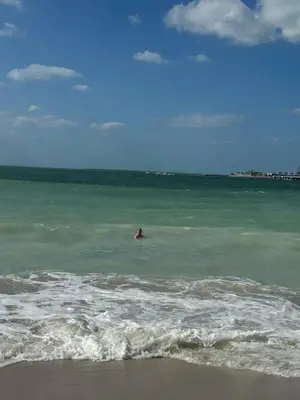 a person swimming in the ocean on the beach at Magic JBR & Dubai marina in Dubai