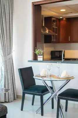 a dining table and two chairs in a kitchen at BellaVista - Sophisticated - 2 BR - 29 Boulevard - Burj Khalifa & Fountain View in Dubai