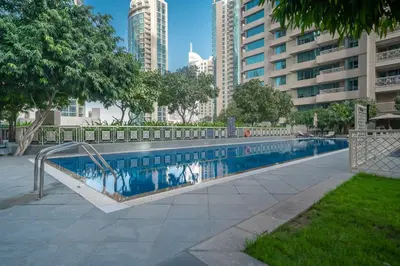 a swimming pool in a city with tall buildings at BellaVista - Sophisticated - 2 BR - 29 Boulevard - Burj Khalifa & Fountain View in Dubai