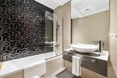 a bathroom with a sink and a toilet and a shower at Unlock Metropolis Business Bay in Dubai