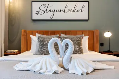 two white swans towels on a bed at Unlock J One Downtown Dubai in Dubai