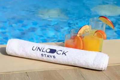 a rolled up paper towel with two glasses of orange juice at Unlock J One Downtown Dubai in Dubai