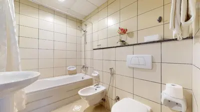 a white bathroom with a toilet and a sink at MP12 - Luxurious 2BR in Marina Pinnacle Tower in Dubai