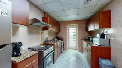 a kitchen with a sink and a stove top oven at MP12 - Luxurious 2BR in Marina Pinnacle Tower in Dubai