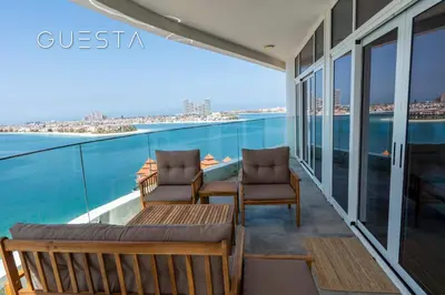 a balcony with chairs and a view of the water at Azizi Mina The Palm, Free beach and pool access in Dubai