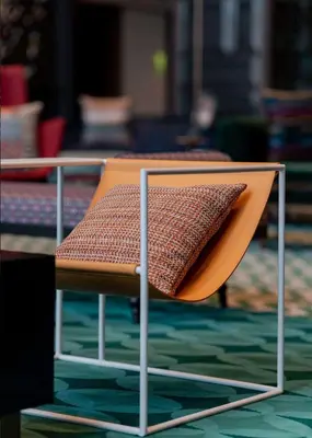 a chair with a pillow sitting on top of it at Hyatt Centric Jumeirah Dubai in Dubai