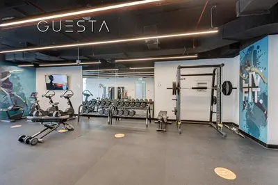 a gym with treadmills and weights in a room at LIV Residence, Dubai Marina in Dubai
