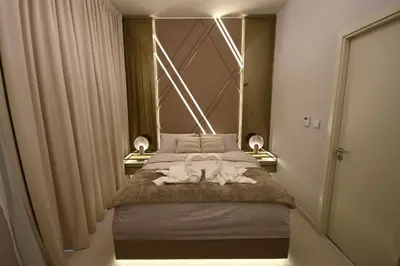 a bedroom with a bed with two white towels on it at Smart Living Villa in Dubai