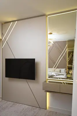 a room with a tv on a wall with a mirror at Smart Living Villa in Dubai