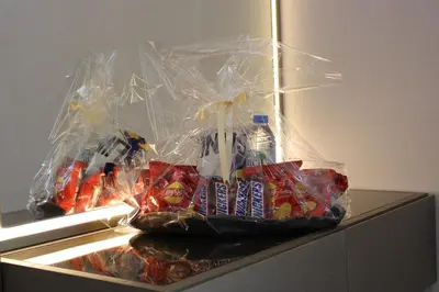 a refrigerator filled with snacks and drinks on a counter at Smart Living Villa in Dubai