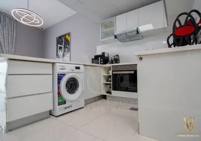 a kitchen with a washer and dryer in it at Dubai marina , Success Luxury apartments, near JBR beach and metro station-daily free housekeeping included in Dubai