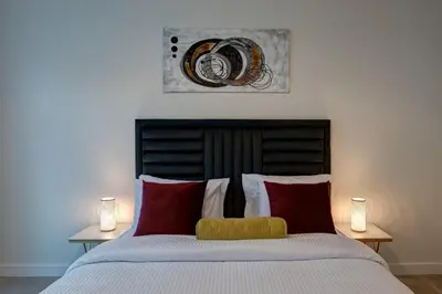 a bedroom with a large bed with red and white pillows at Durrani Homes - Arabian luxury at Souk Al Bahar besides Burj Khalifa & Dubai Mall in Dubai