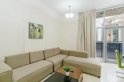 a living room with a couch and a table at RH- Modern Urban Oasis, Spacious 02RB near mall of Emirates in Dubai
