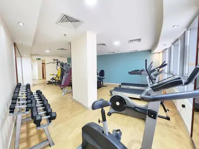 a gym with treadmills and ellipticals in a room at RH- Modern Urban Oasis, Spacious 02RB near mall of Emirates in Dubai
