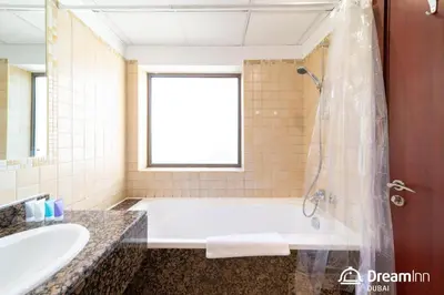 a bathroom with a tub and a sink at Dream Inn Apartments - Rimal JBR in Dubai