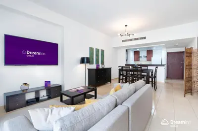 a living room with a couch and a dining room at Dream Inn Apartments - Rimal JBR in Dubai