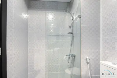a bathroom with a shower with a glass door at Captivating Studio at Giovanni Boutique Suites DSC by Deluxe Holiday Homes in Dubai