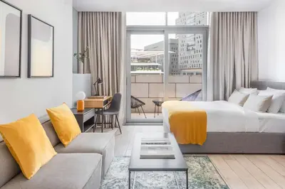 a hotel room with a bed and a couch at Silkhaus newly furnished modern DIFC studio with balcony in Dubai