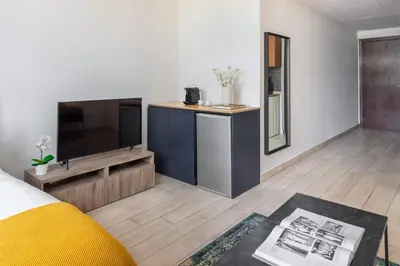 a living room with a tv and a couch at Silkhaus newly furnished modern DIFC studio with balcony in Dubai