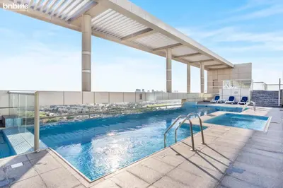 a swimming pool on top of a building at bnbmehomes - The Medalist in Dubai