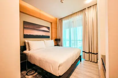 a hotel room with a bed and a window at Emaar Fashion Avenue one bedroom - Formerly Address Dubai Mall Four Apple Holiday Homes in Dubai