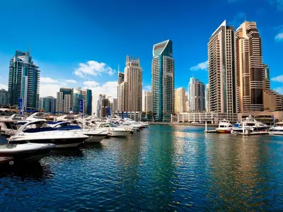 a group of boats docked in a harbor in a city at HVR THE PALM DUBAI in Dubai