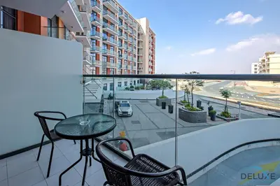 a balcony with a table and chairs on a building at Immaculate Studio at DAMAC Celestia by Deluxe Holiday Homes in Dubai