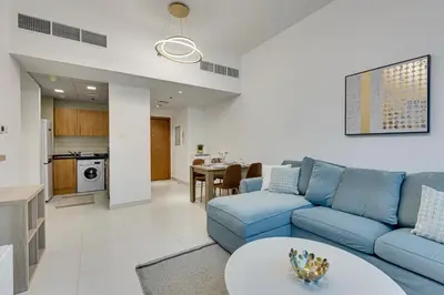 a living room with a blue couch and a table at Great views from New apartment in Dubai Marina in Dubai