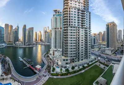 a view of a city with tall buildings and a river at Great views from New apartment in Dubai Marina in Dubai